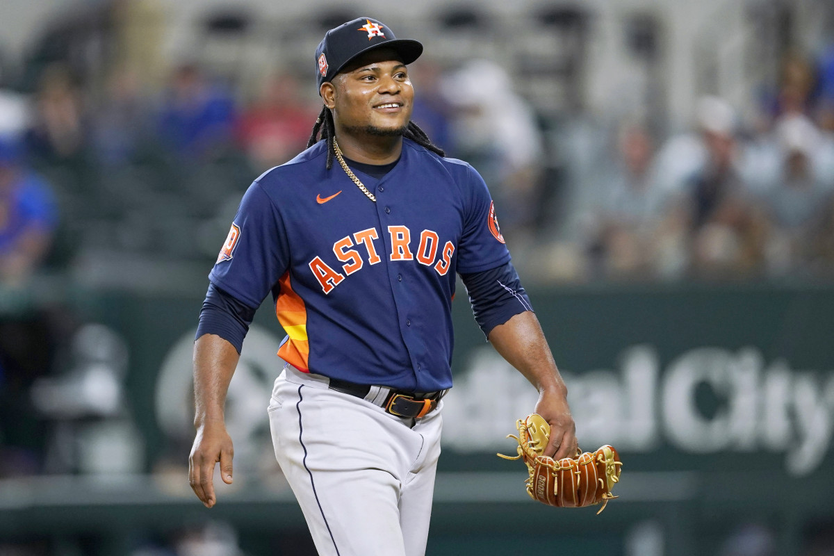 Houston Astros’ Framber Valdez smiles as he walks to the dugout after working against the Texas Rangers during the eighth inning of a baseball game in Arlington, Texas, Tuesday, Aug. 30, 2022.